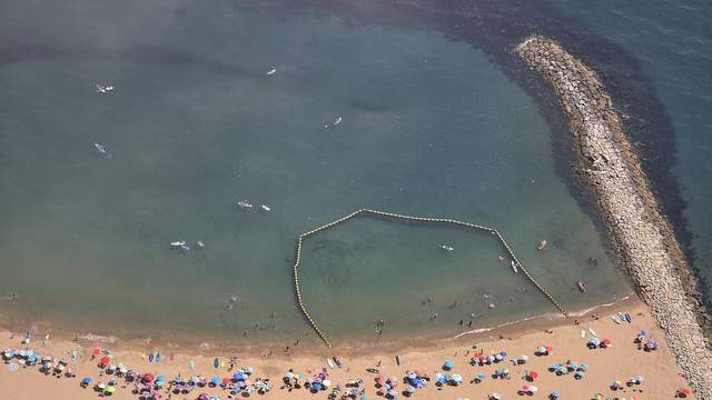 Looking straight down on a busy beach from high on the Rock