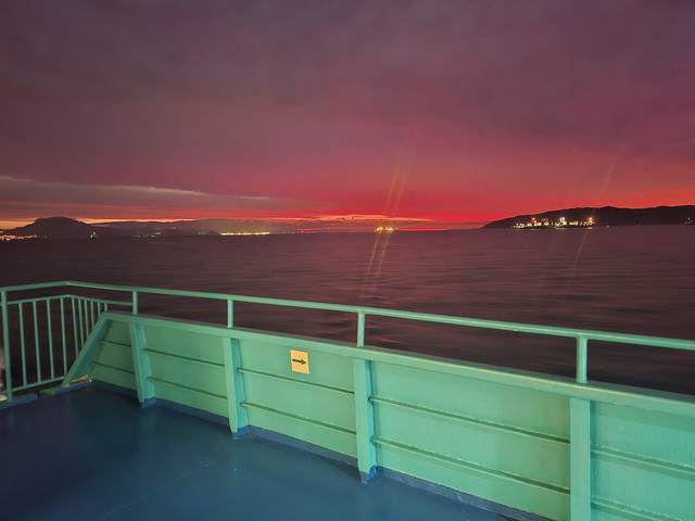 Red sunset over the Bay of Gibraltar from a ferry deck
